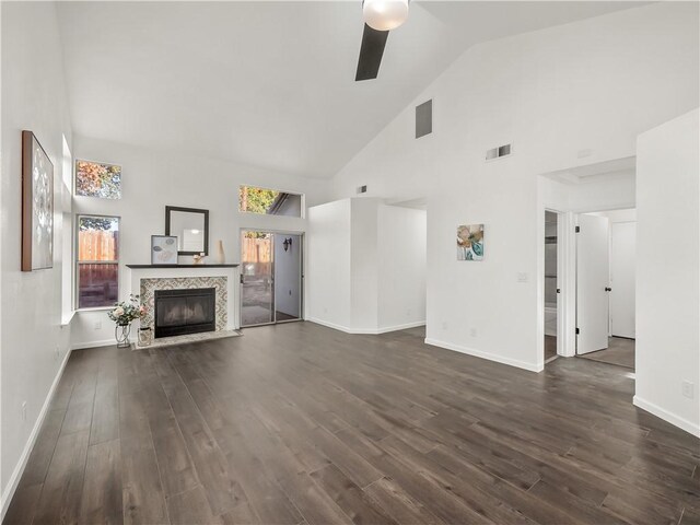 unfurnished living room featuring ceiling fan, dark hardwood / wood-style flooring, and high vaulted ceiling