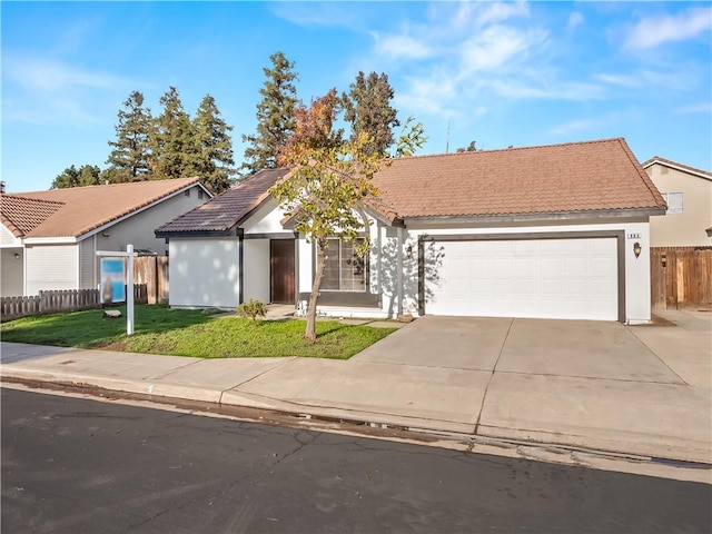 view of front of house featuring a garage and a front lawn