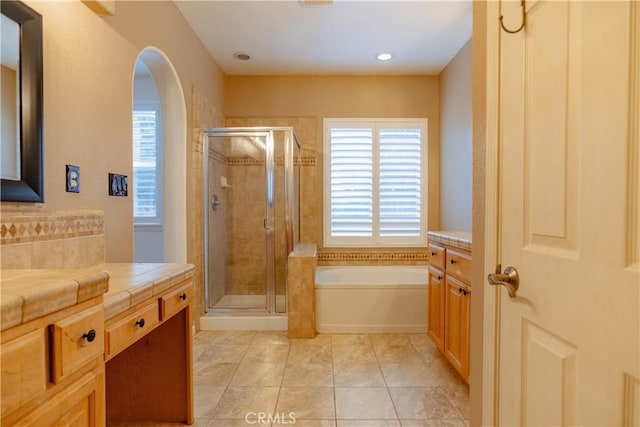 bathroom featuring independent shower and bath, vanity, and tile patterned floors