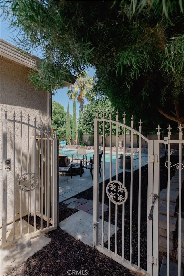 view of gate featuring a community pool