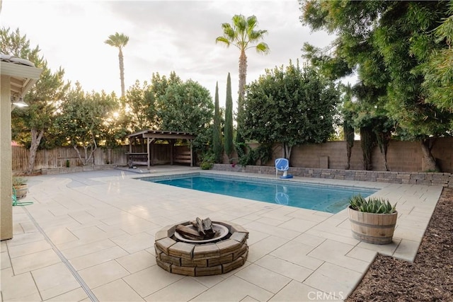 view of pool featuring a gazebo, a patio area, and an outdoor fire pit