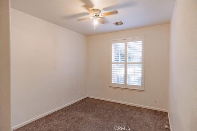 empty room featuring carpet floors and ceiling fan