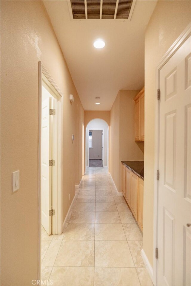 corridor with light tile patterned floors