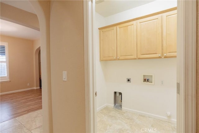 laundry area featuring light tile patterned floors, hookup for a washing machine, cabinets, and hookup for an electric dryer