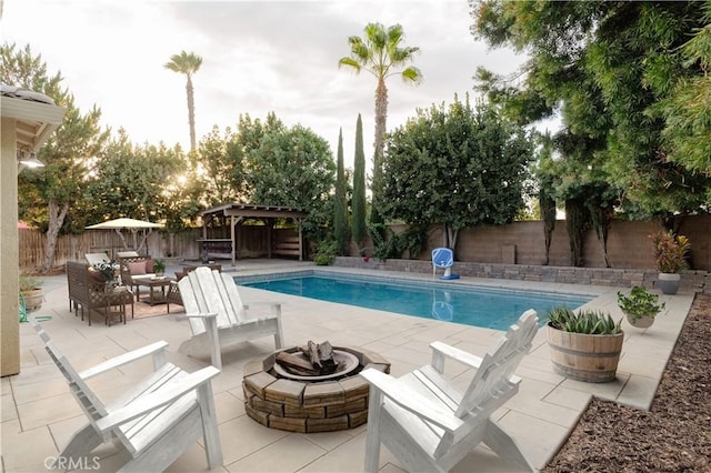 view of swimming pool featuring a gazebo, a patio area, and an outdoor living space with a fire pit