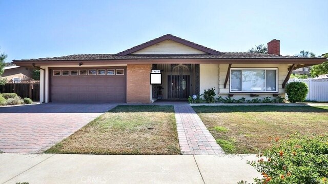 view of front of home with a garage and a front yard