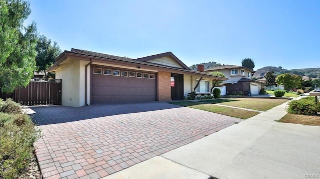 view of front of house featuring a garage and a front yard