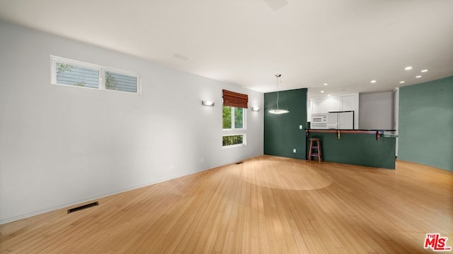 unfurnished living room featuring light wood-type flooring