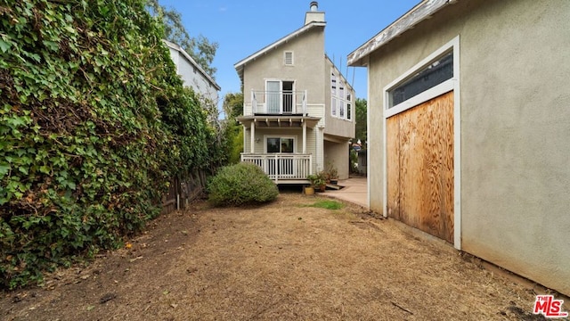 rear view of house featuring a balcony