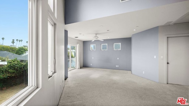 empty room featuring light carpet and ceiling fan