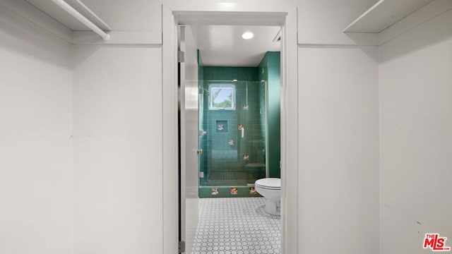 bathroom with toilet and an enclosed shower