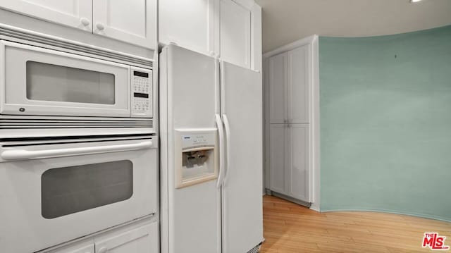 kitchen with light hardwood / wood-style flooring, white cabinets, and white appliances