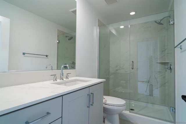 bathroom with toilet, a shower with door, and vanity