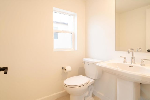 bathroom featuring sink, tile patterned floors, and toilet