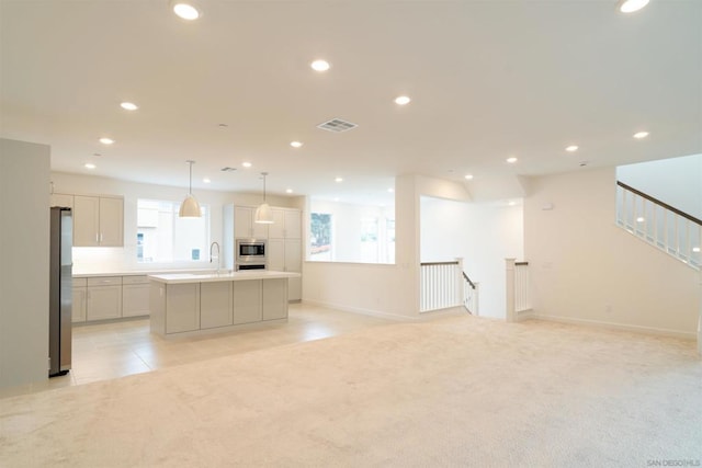 interior space featuring light colored carpet and sink