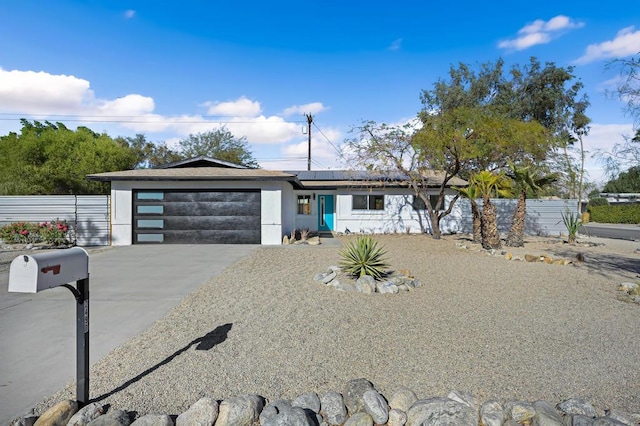 view of front of house with a garage and solar panels