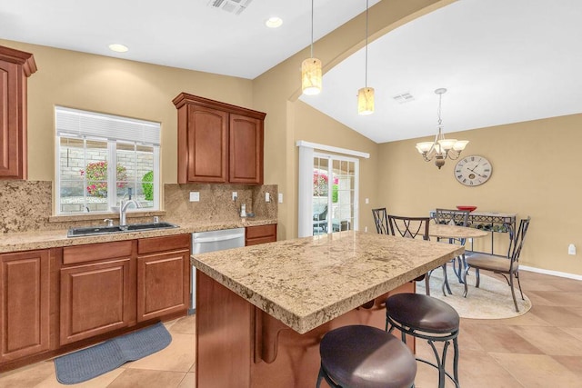 kitchen with tasteful backsplash, vaulted ceiling, a center island, sink, and an inviting chandelier