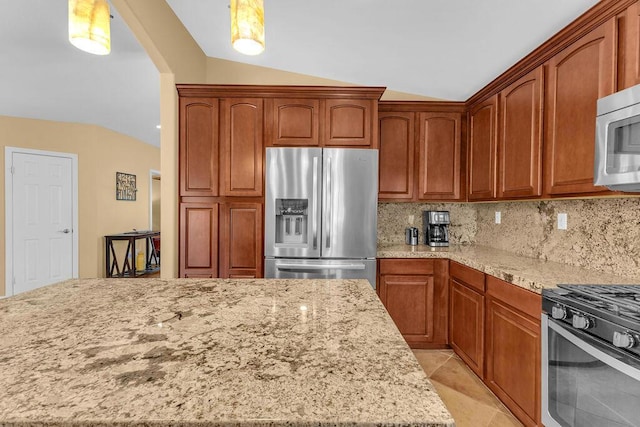 kitchen with appliances with stainless steel finishes, backsplash, light stone countertops, vaulted ceiling, and pendant lighting