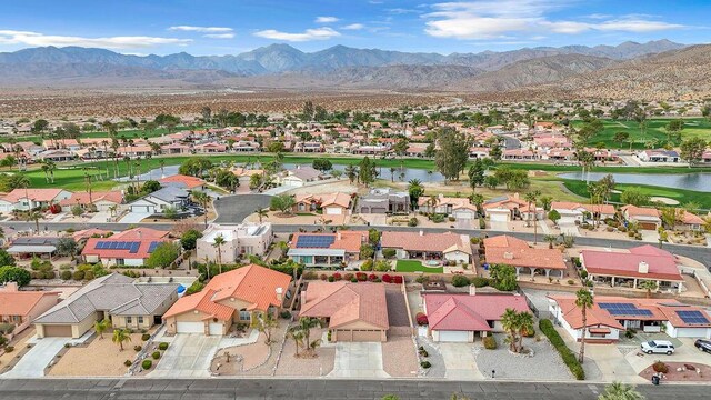 birds eye view of property featuring a water and mountain view