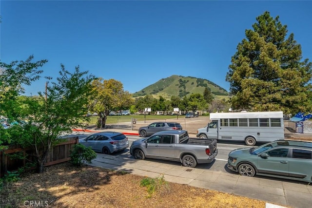 view of parking / parking lot featuring a mountain view