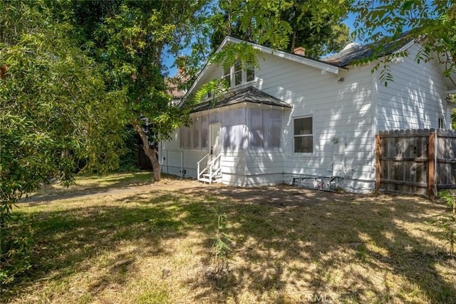 view of side of home featuring a yard