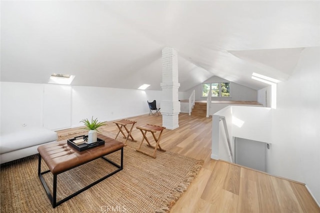 living room with lofted ceiling and light hardwood / wood-style floors