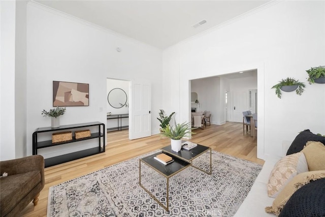 living room with hardwood / wood-style flooring and crown molding