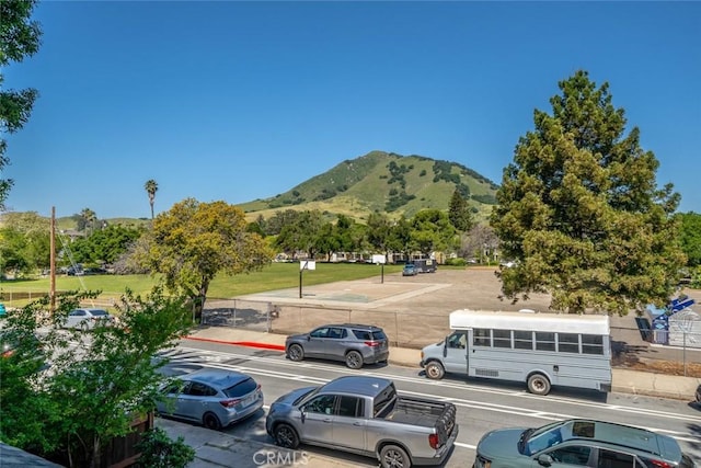 view of car parking featuring a mountain view