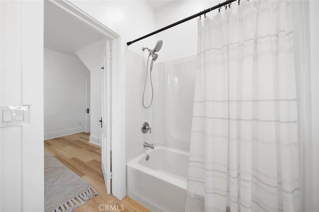 bathroom featuring hardwood / wood-style flooring and shower / bath combo