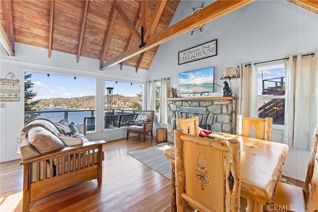 347 Emerald Dr, Lake Arrowhead, CA 92352 - dining space with hardwood / wood-style flooring, high vaulted ceiling, a fireplace, plenty of natural light, and a wooden ceiling with exposed beams