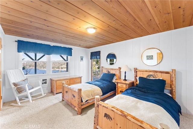 bedroom with a water view, wooden ceiling, and light colored carpet