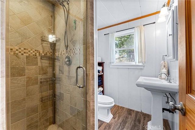 bathroom with hardwood / wood-style floors, sink, toilet, walk in shower, and crown molding