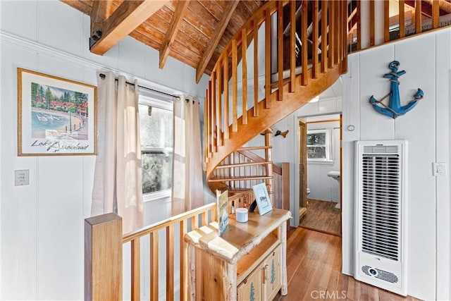 staircase featuring hardwood / wood-style flooring, wooden ceiling, and vaulted ceiling with beams