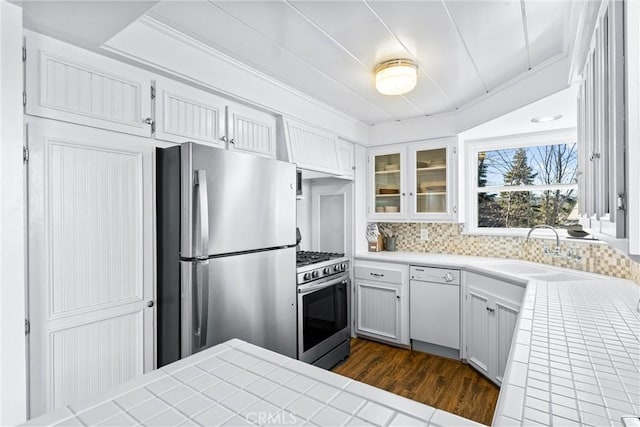 347 Emerald Dr, Lake Arrowhead, CA 92352 - kitchen with stainless steel appliances, tile countertops, dark wood-style floors, and glass insert cabinets