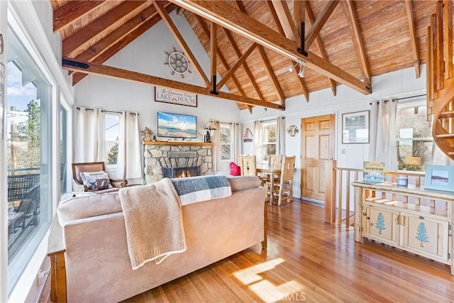 347 Emerald Dr, Lake Arrowhead, CA 92352 - living area featuring wood finished floors, a stone fireplace, high vaulted ceiling, a wooden ceiling with exposed beams, and plenty of natural light
