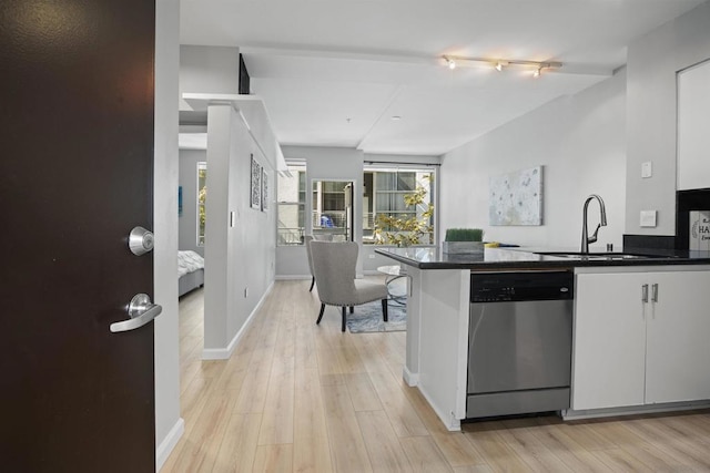 kitchen featuring dishwasher, light hardwood / wood-style flooring, track lighting, white cabinetry, and sink