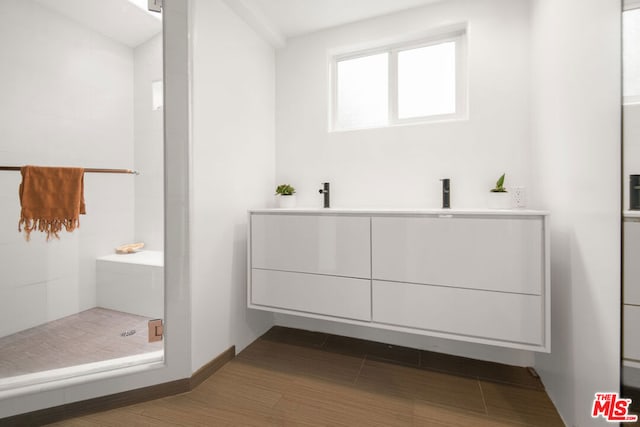 bathroom with a shower and vanity