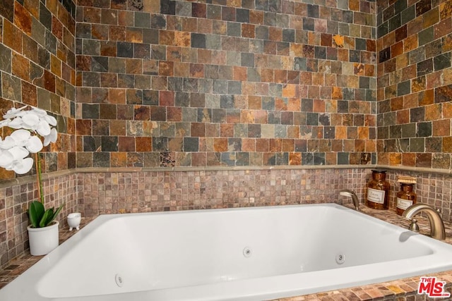 bathroom featuring a relaxing tiled tub