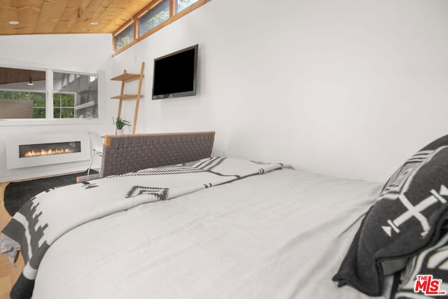 bedroom featuring vaulted ceiling and wooden ceiling