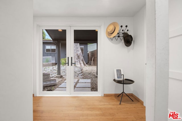 doorway featuring light hardwood / wood-style floors and french doors