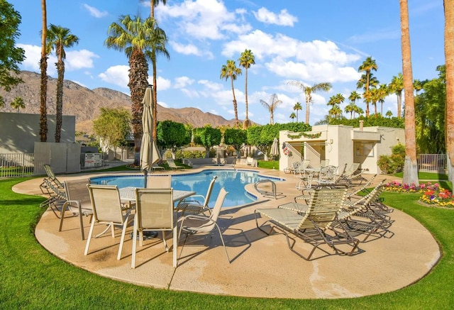 view of pool featuring a mountain view and a patio