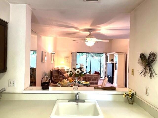 kitchen featuring ceiling fan and sink