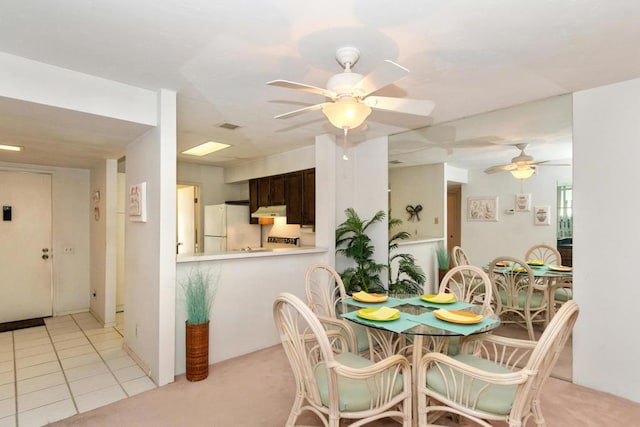 tiled dining area featuring ceiling fan