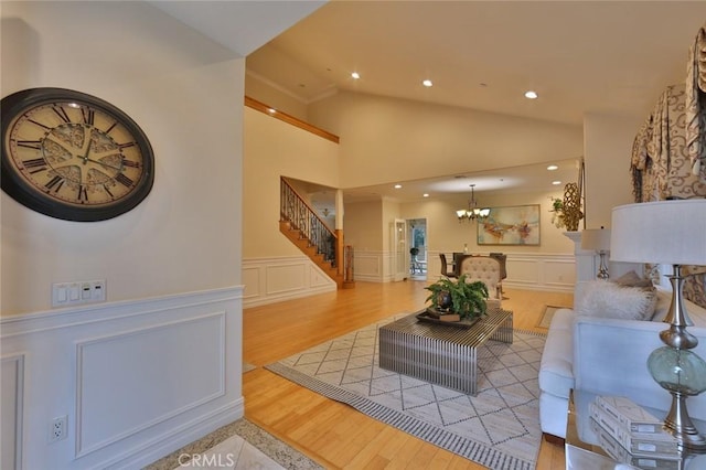 living room featuring high vaulted ceiling and hardwood / wood-style flooring