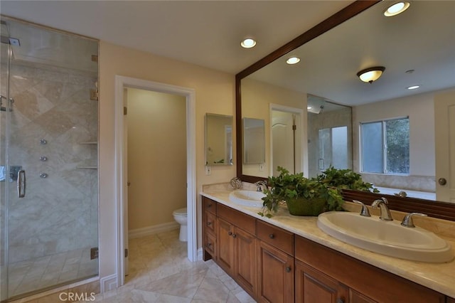 bathroom with toilet, an enclosed shower, and vanity