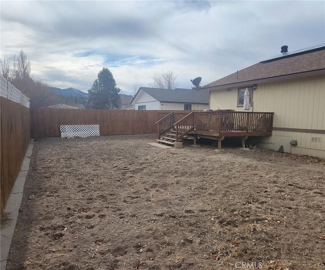 view of yard featuring a deck with mountain view