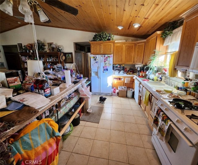 kitchen featuring light tile patterned flooring, lofted ceiling, sink, wood ceiling, and white appliances