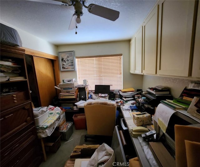 home office featuring ceiling fan and light carpet