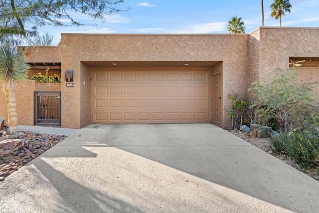 pueblo-style house with a garage