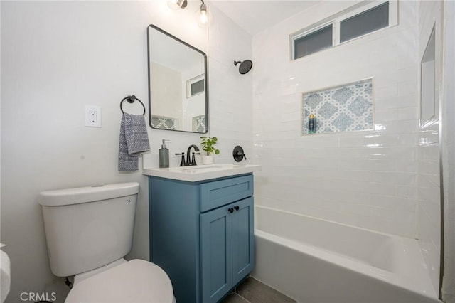 full bathroom with toilet, vanity, and tiled shower / bath